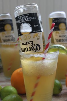 oranges, limes and lemonade are arranged on a table