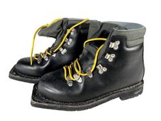 a pair of black boots with yellow laces