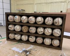 a display case filled with baseballs inside of a building