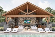 an outdoor living area with couches and a television on the wall next to a swimming pool