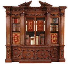 an old wooden bookcase with many books on it's sides and ornate carvings