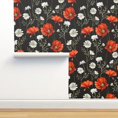 the wall paper has red and white flowers on it, along with a black background