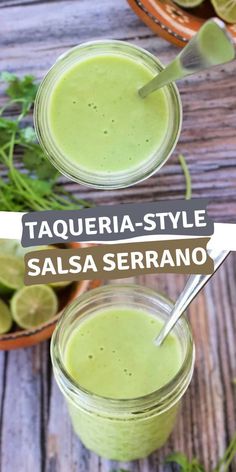 two jars filled with green smoothie next to limes and cilantro on a wooden table