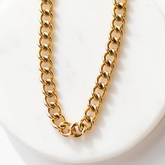 A bold and modern piece of ethically made jewelry, our Parker Necklace is equally on trend and simply timeless. Our thick link chain, this statement piece can shine on its own or be used as a solid base alongside other layering necklaces. Pair it with a long pendant like our Blaire Necklace or a delicate choker like our Chloe. Details: Ethically made 14k gold plated stainless steel chain 100% of the profit from the sale of Sela Designs Jewelry is donated to charity. Delicate Choker, Leather Store, Tagua Jewelry, Layering Necklaces, Clear Plastic Bags, Donate To Charity, Long Pendant, Layering Necklace, Leather Cleaning