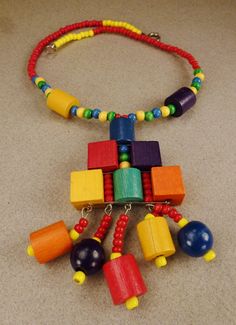 A stunning colorful Studio handcrafted artistic necklace with a rich combination medley of different sized wooden beads in brilliant red blue yellow green cylinders rectangles andround beads necklace as you can see from the pictures. It is in excellent vintage condition with a nicely closing tieback as seen in photo. It measures 14 inches long and is 3 inches at it's widest. A welcome one of a kind necklacesummer present that will delight it's new owner! Unique Multicolor Rectangular Necklace, Unique Multicolor Necklace, Artistic Necklace, Colorful Studio, Seashell Pendants, Coloring Apps, Cut Out Design, Beads Necklace, Chicago Il