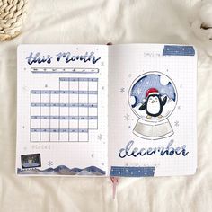 an open planner book with a penguin on it