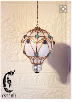 a white light bulb hanging from a chain