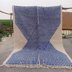 a blue and white striped rug on the ground