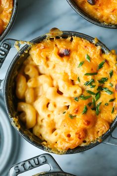 three skillets filled with macaroni and cheese