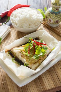 a plate with fish and rice on it