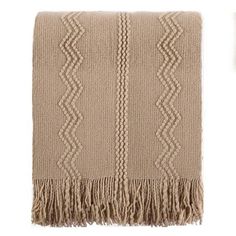 a beige blanket with fringes on the bottom and an image of a white background