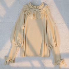 Size 			S 			M 			L 		 		 			Full Length 			56 			58 			60 		 		 			Bust 			80 			84 			88 		 		 			Waist 			70 			74 			78 		 		 			Neck Circumference 			18 			19 			20 		 		 			Sleeve Length 			58 			59 			60 Cream Solid Color Top For Fall, Cream Knit Top For Fall, Casual Cream Sweater With Ruffles, Long Sleeve Sweater With Ruffles For Fall, Cream Ruffled Sweater For Spring, Beige Ruffled Sweater For Winter, Beige Knit Tops With Ruffles, Fall Ruffled Knit Tops, Fall Knit Tops With Ruffles