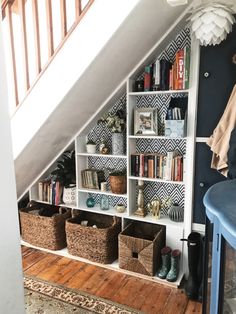 an image of a room with bookshelves and baskets on the shelves in it