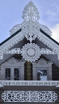 the top of a building with a clock on it's face and an intricately designed roof