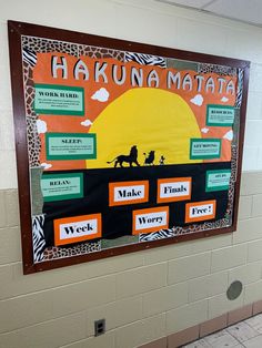 a bulletin board with words and pictures on it in a school hallway, showing information about hakuna mata