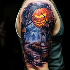 a man's arm with a halloween scene on it and pumpkins in the background