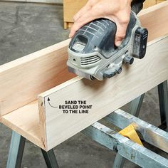 a person using a power tool on a piece of wood