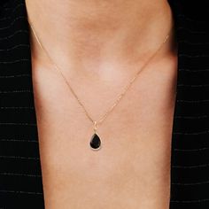 Embrace the mystique of our black onyx pendant necklace, showcasing a AAA quality 10x7mm pear-shaped, natural faceted onyx, securely bezel-set. Available in 14K gold filled or sterling silver. Customize the chain length for a perfect fit. An excellent choice for 7th-anniversary jewelry gift.    14K GOLD FILLED JEWELRY    - Gold-filled jewelry is composed of a solid layer of gold (typically constituting at least 5% gold) mechanically bonded to a base metal.  - Given the gold content and construct Black Onyx Pendant, Onyx Pendant, 7th Anniversary, Solitaire Pendant Necklace, Anniversary Jewelry, Solitaire Pendant, Brass Material, Gold Filled Jewelry, Jewelry Gold