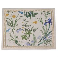 a white placemat with blue and yellow flowers on it