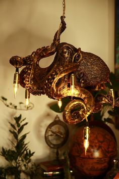 an octopus chandelier hanging from a ceiling in a living room with other decorations