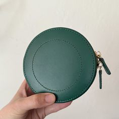 Who doesn't love a round case! Such a fun design made of forest leather and stunning gold accents. The LutreLoc interior keeps your jewelry from tarnishing and organized. It's the perfect little case for travel or everyday storage. Measures: 4.5" L x 4.5" W x 2" H Storage: 1 bracelet compartment with charm/ring well Compact Green Wallet For Travel, Compact Green Travel Wallet, Compact Green Wallets For Gifts, Green Leather Coin Purse For Gift, Charm Ring, Charm Rings, Jewelry Case, Everyday Jewelry, Gold Accents