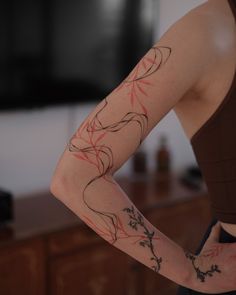 a woman's arm with tattoos on it