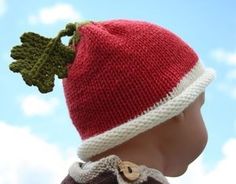 a knitted red and white hat on top of a mannequin's head