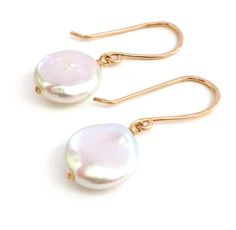 These off-white coin pearl earrings are classic and chic. These natural freshwater coin pearls are naturally an off-white-ish pink color and dangle from hand hammered gold filled ear wires. These earrings measure about 1 1/4 inches from top to bottom.Select them in 14k gold filled or 14k solid gold.What is 14k gold filled wire? It is 14 karat gold coated over alloy metal which may contain brass, nickel, steel and other metals and 1000x thicker than gold plated. It will last several decades or ev Anthropologie Lookbook, Coin Pearl Earrings, Pearl Bracelet Wedding, White Pearl Earrings, Pearl Jewelry Design, White Pearl Earring, Coin Pearls, Hammered Gold, Wedding Jewelry Earrings