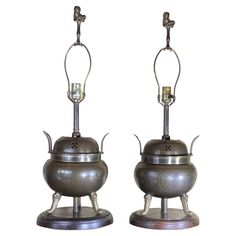 two metal lamps sitting on top of each other