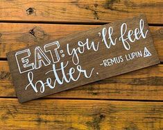 a wooden sign that says eat you'll feel better, and the words below it are