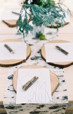 the table is set with place settings for guests to sit down and write on paper