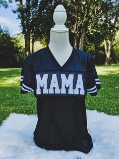 a mannequin wearing a football jersey with the word mama on it