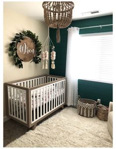 a baby's room decorated in green and white