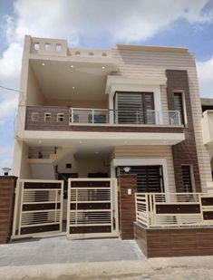 a two story house with brown and white walls