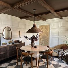 a dining room with a checkered floor and white walls