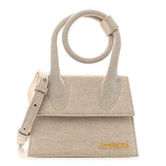 This is the authentic Linen Le Chiquito Noeud in Light Greige. This chic bag is crafted of linen fabric in beige. It features a curled top handle, an optional leather shoulder strap, and gold hardware. The front flap opens to a beige fabric interior with a patch pocket. Jacquemus Linen, Chic Bags, Beige Fabric, Bag Straps, Linen Fabric, Gold Hardware, Patch Pocket, Top Handle, Calf Skin