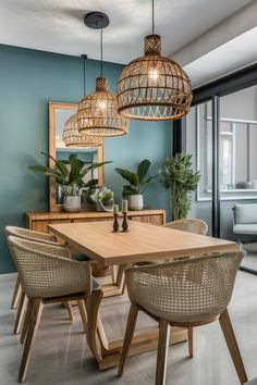 a dining room table and chairs in front of a window with blue walls, potted plants and hanging lights