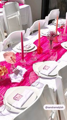 the table is set with pink and white linens