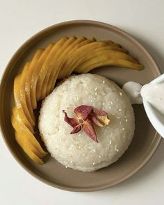 a plate topped with rice and sliced mangos