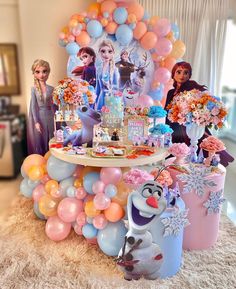 a frozen princess birthday party with balloons and decorations