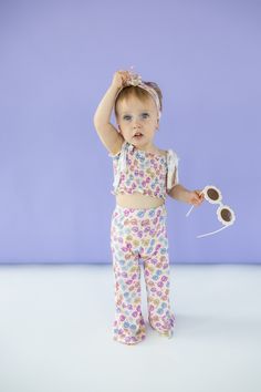 Bask in summer's warmth with our Ray of Sunshine Dream Smocked Flare Set. Made from bamboo material, this smocked flare set is not only comfortable, but also environmentally friendly. With a playful sunglasses print, this outfit is perfect for girls to rock in the summer or spring. Made from theÂ softest and most breathable seasonal bamboo viscose material, your babe won't want to take this off! Designed for all the loveÂ and extra play!Â Our Ray Of Sunshine, Sunglasses Print, Tuxedo Accessories, Toddler Flower Girls, Girls Gloves, Girls Dress Outfits, Toddler Flower Girl Dresses, Bamboo Material