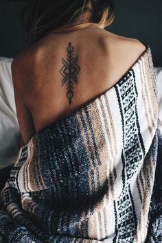 a woman with a tattoo on her back