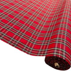 a red tarp with white and black plaid pattern on the bottom, rolled up