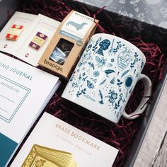 a coffee mug and some books in a box