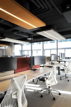 an empty office with multiple desks and chairs