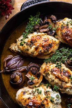 chicken with mushrooms and herbs in a skillet