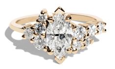 a gold ring with three pear shaped diamonds