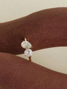 a diamond ring sitting on the palm of someone's hand