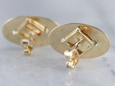 Beautifully polished and simple-as-can-be in design. These gleaming yellow gold oval studs were adapted from a pair of antique cufflinks and given a bright polish. Wear these minimalist studs everyday with a suit-dress or jeans! Market Square Jewelers works with one of the finest hand engravers in the northeast. With over 30 years of experience, our engraver hand carves lettering, monograms, crests, or patterns in period-specific styles. Choose from our many monogram options shown in the listing Classic Yellow Gold Oval Cabochon Earrings, Classic Yellow Gold Oval Cufflinks, Classic Oval Yellow Gold Cufflinks, Plain Gold Earrings, Antique Cufflinks, Monogram Earrings, Oval Stud Earrings, Market Square, Minimalist Studs