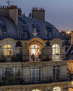 an old building with lots of windows and balconies on top of it at night